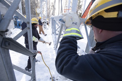 workers working on a transformer